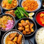 An array of colorful Asian dishes neatly prepared